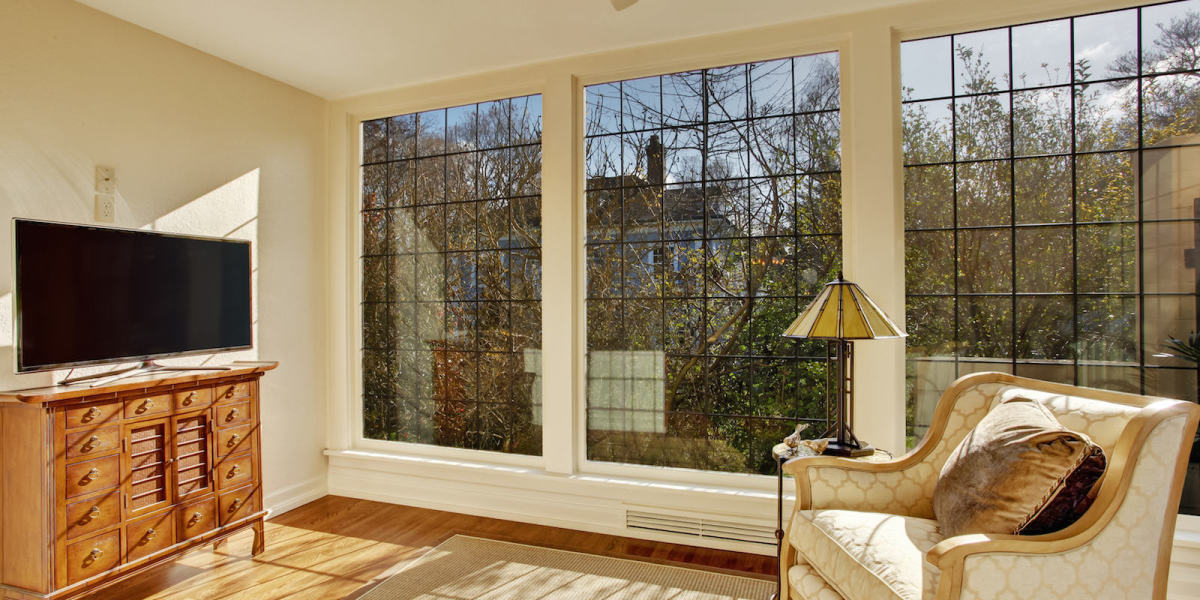 Bright sunroom with antique chair and tv