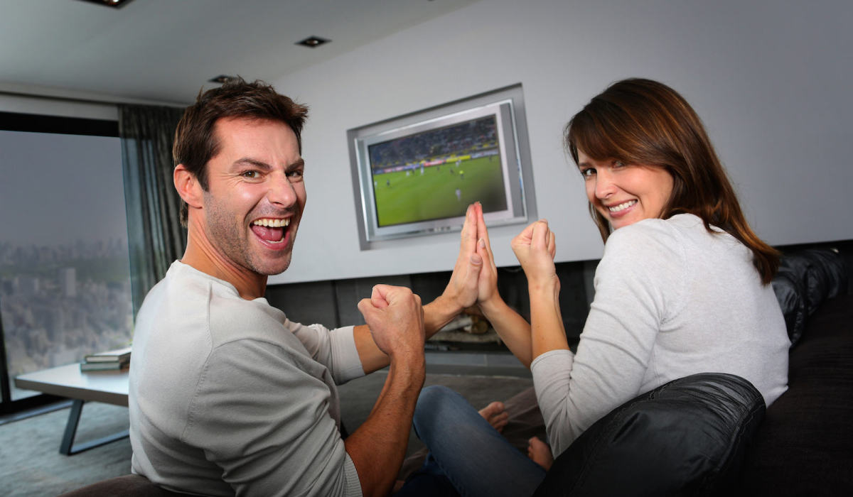 Couple having fun watching soccer game